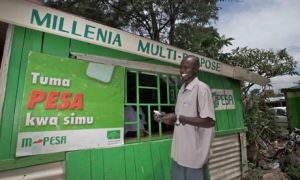 A young man outside an M-Pesa store